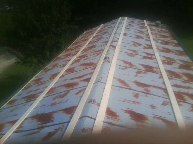 Rusted metal roof panels with new wood purlins before replacement — Storm Damage Roof Repair in Latta by Roofing Brothers